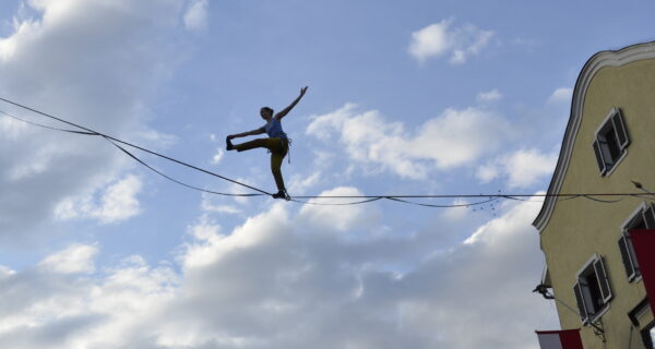 A person balances on a highline above Innsbruck's old town.